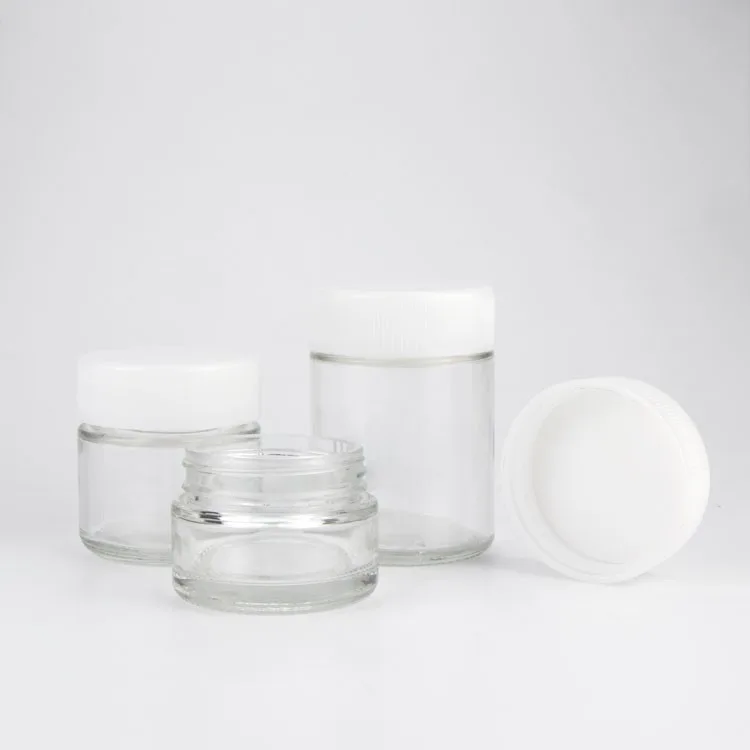 Den 2oz Clear CR Glass Jar, en rese storlek, som är perfekt för läkemedel, ör...